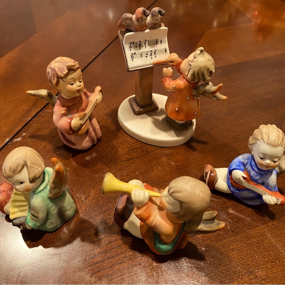 Hummel figurines Five piece set of angels playing music and a conductor.